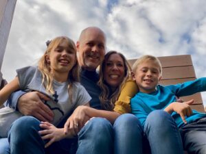 Family with clouds behind them