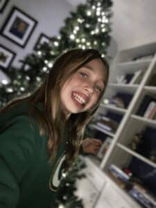 Girl in front of Christmas tree