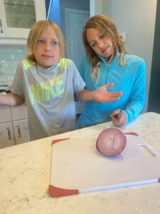 two children with the core of an onion