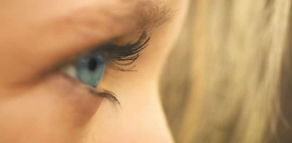Close-up sideways view of a woman's eye, as if observing