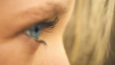 Close-up sideways view of a woman's eye as if observing