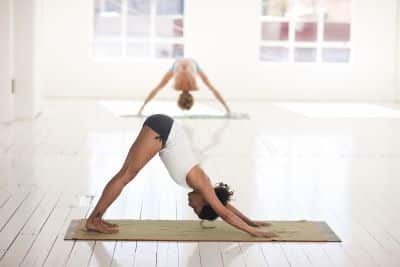 Woman in downward dog position in yoga class
